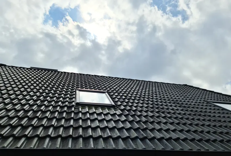 New tiled roof with a roof window completed by a roofer in Harrogate